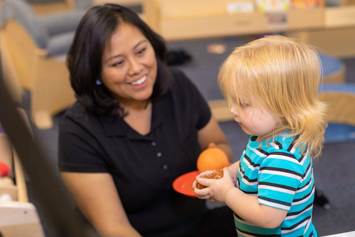 caregiver and kid playing together
