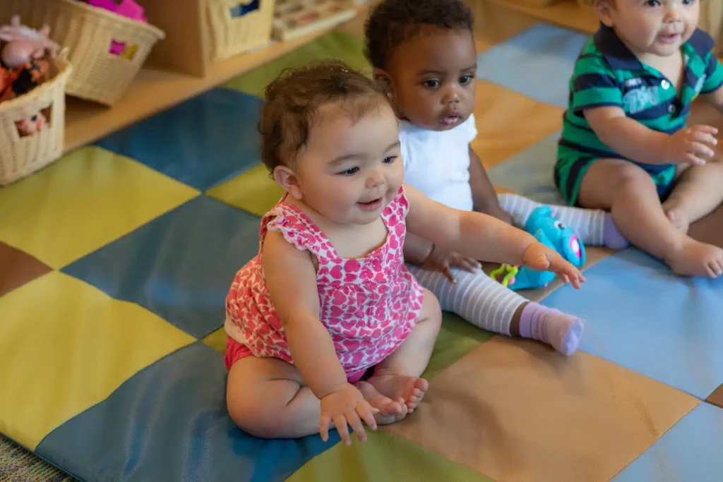 Smiling toddlers enjoying playtime at Sunrise Children’s Foundation, showcasing the impact of early childhood programs—become a sponsor to support their future.