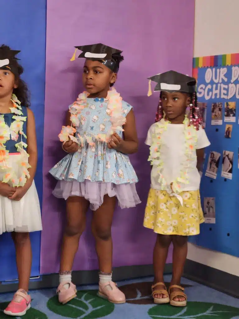 Young graduates in colorful outfits and graduation caps at a Head Start ceremony, highlighting head start employment opportunities and the role of a head start education coordinator.