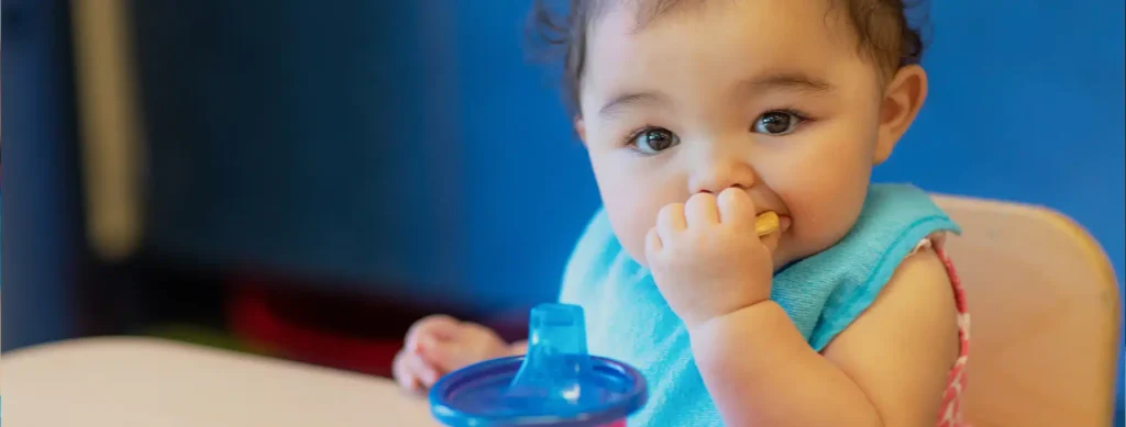 Young child enjoying a healthy snack at Sunrise Children’s Foundation—become a sponsor to support early childhood nutrition and wellness programs.