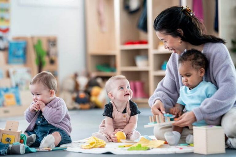 A caretaker engages with children in an early education setting.
